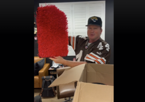 Barstool Sports unboxing the red turf from his package.